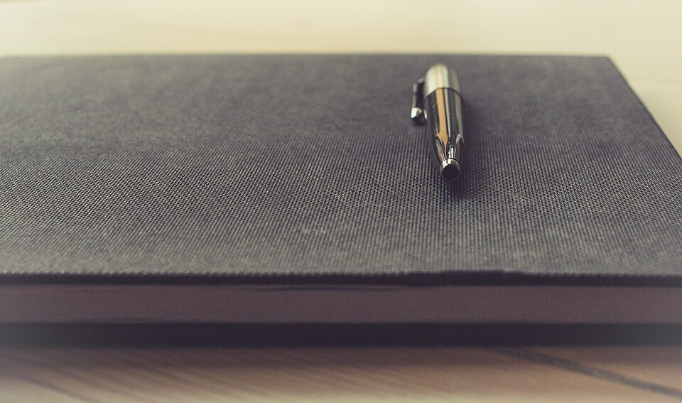 Pen resting on a notebook used for writing practice